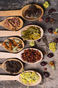 Nature medicine . Herbs in wooden spoon with spase for text .